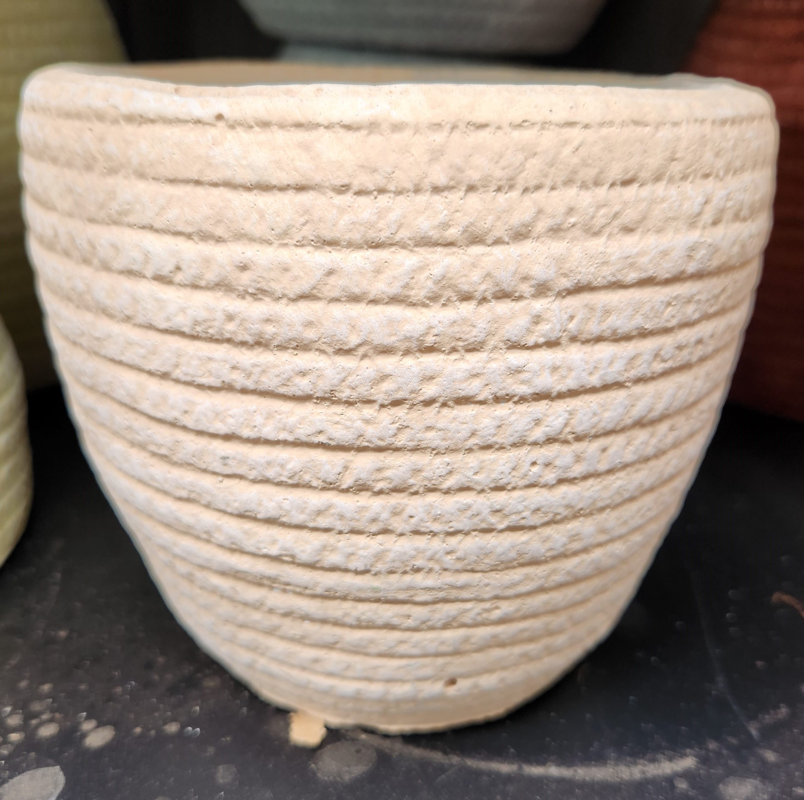 A Dart Weave Egg Pink M 19x18cm ceramic pot sitting on a shelf.