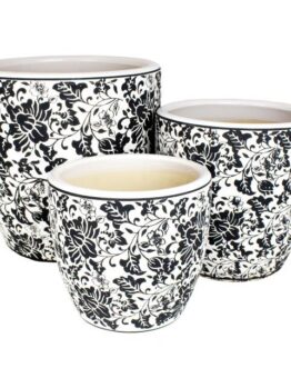 A set of three different sized plant pots with saucers black and white floral design