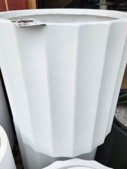 The GardenLite Grecian Cylinder White S 39x39cm planter stands upright with a price tag on its rim, displayed next to other similar-sized pots.