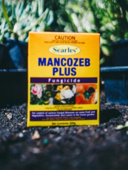 A box of Searles Mancozeb Plus Fungicide 200g sitting on the ground.