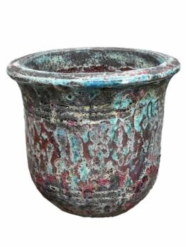 A weathered ceramic Seafoam Verona Planter Aqua 30x26cm, featuring a wide rim and a textured, multicolored surface with shades of green, blue, and reddish-brown.