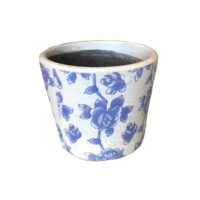 White ceramic pot with blue floral patterns on the surface.