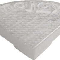 A translucent, wedge-shaped plastic object with a textured surface, "mojay" embossed on top, and a subtle hint of Glazed Cylinder White XL 50x50cm in its finish.