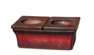 A rectangular red ceramic African Violet Dual Self-Watering Planter (18x12x7cm) with two side-by-side circular openings on top, shown against a white background.