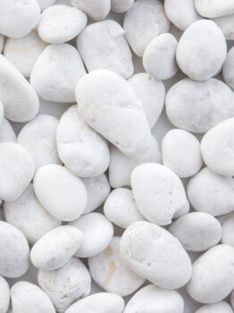 Pebbles Snow White 10-30mm 20kg Bag features smoothly polished pebbles in varying sizes, closely arranged for a refined look.