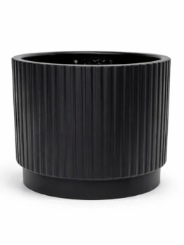 A black, cylindrical planter with vertical grooves sits on a solid base against a white background.