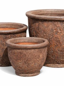 Three round, textured, brown ceramic plant pots of varying sizes are arranged side by side on a white background.