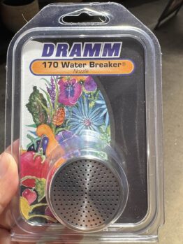 A hand holds a packaged DRAMM 170 Water Breaker Nozzle, featuring a metal spray head and colourful floral artwork on the label.