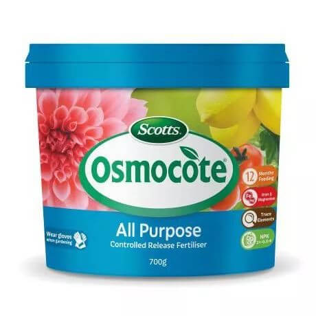 A 700g container of Osmocote Controlled Release Fertiliser: Total All Purpose, featuring flowers and vegetables on the label and key product highlights.