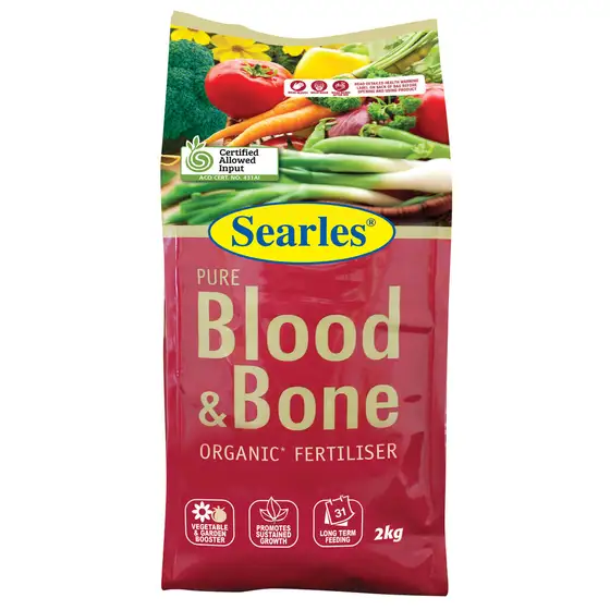 A 2kg bag of Searles Pure Blood & Bone organic fertiliser with a red label and images of vegetables on the packaging.